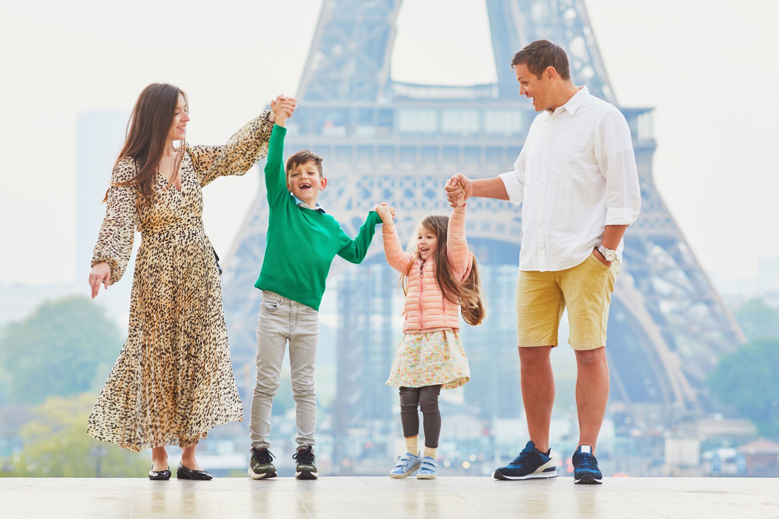 Happy_family_of_four_enjoying_their_trip_to_Paris_France_e0559d9f76